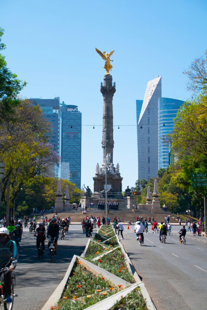 mexico city vacation showing El Zocalo plaza with Metropolitan Cathedral at sunset surrounded by crowds and historic buildings in Centro Historico