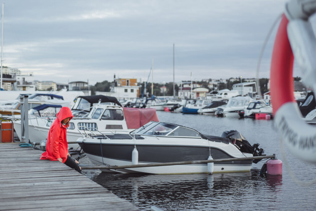 boat repair shop showing a marine mechanic working on an outboard motor representing common boat repair services and how to find local help near you