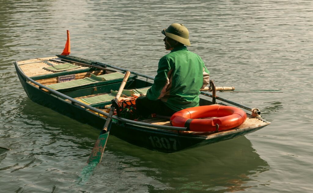 paddle boat on a lake showing a pedal-powered watercraft with two seats representing what to consider when buying a paddle boat