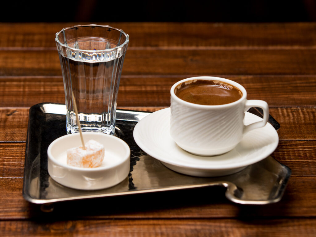HCMC coffee showing a traditional Vietnamese ca phe sua da iced coffee with condensed milk next to a pour over V60 setup at a specialty coffee shop in Ho Chi Minh City Saigon