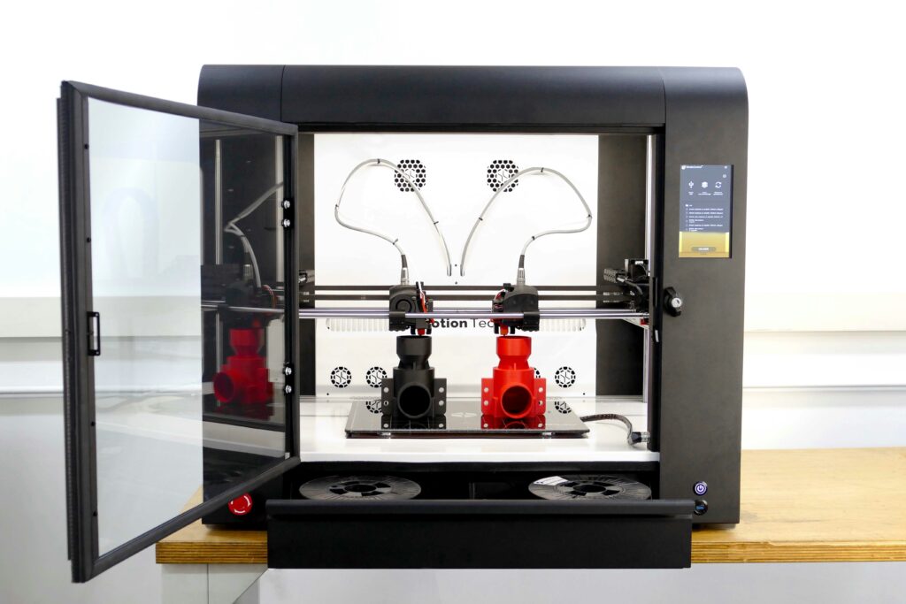 3d printer filament guide showing spools of colorful filament and a filament dryer box representing how to choose store and dry 3d printing materials