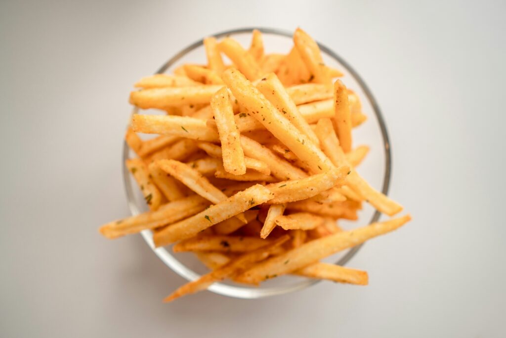 different kinds of french fries showing a variety of french fry cuts and styles including julienne straight cut waffle fries steak fries beer battered and sweet potato fries representing every type of french fry explained