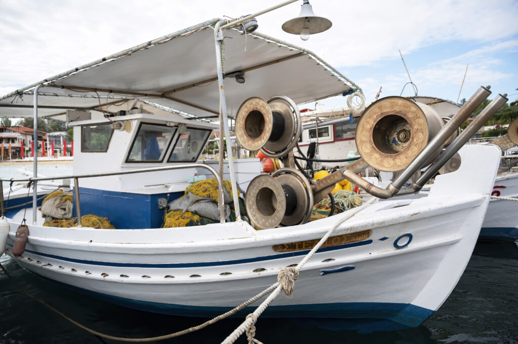 boat repair shop showing a marine mechanic working on an outboard motor representing common boat repair services and how to find local help