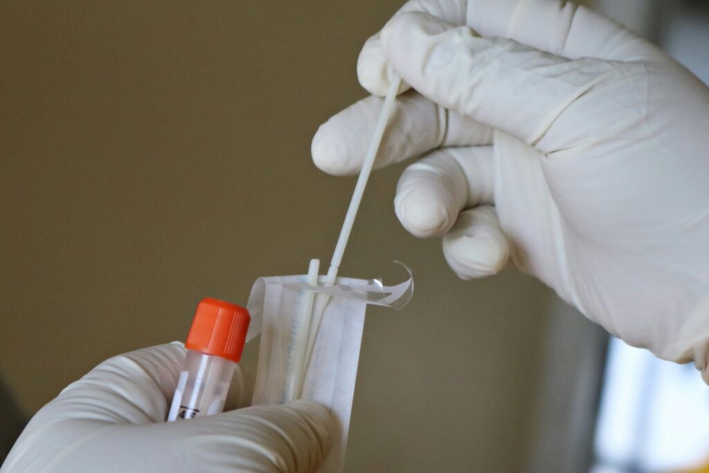 powassan virus test showing a tick and a laboratory test representing powassan virus symptoms testing incubation period and whether dogs can get powassan virus