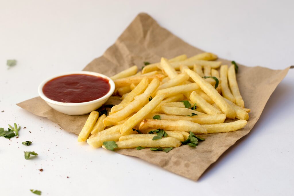 french fry seasoning showing a bowl of homemade spice blend next to crispy golden french fries representing the best french fry seasoning recipes cajun blend Old Bay ranch and the secret to McDonald's flavor