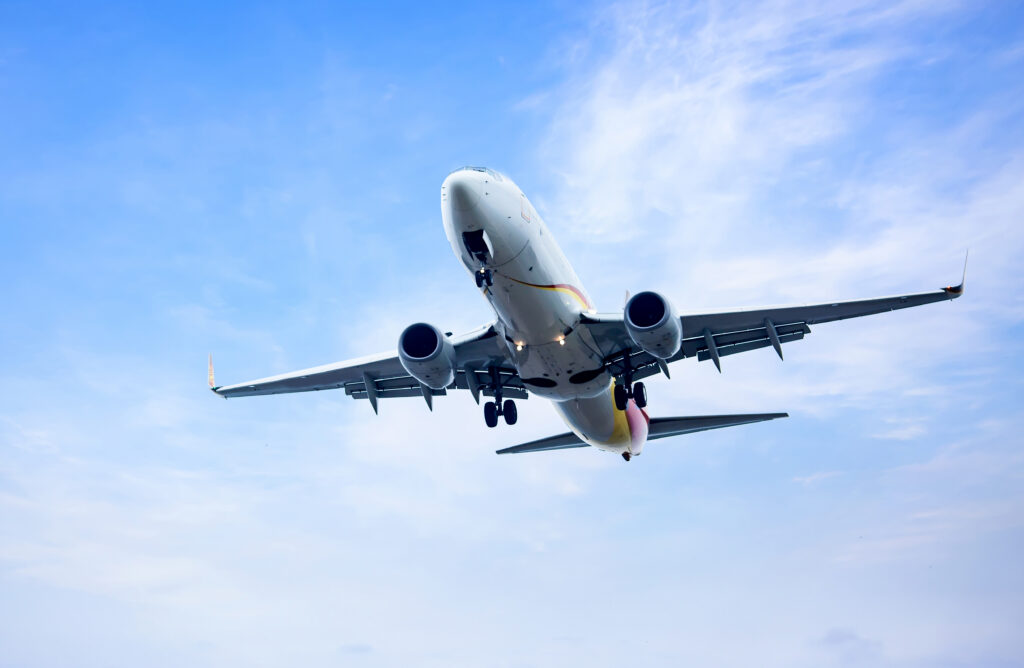 best airlines for international travel showing airplane flying over Europe representing best airlines to fly to Europe from USA best transatlantic airlines best European airlines best business class to Europe Delta vs Lufthansa and best airlines for international flights