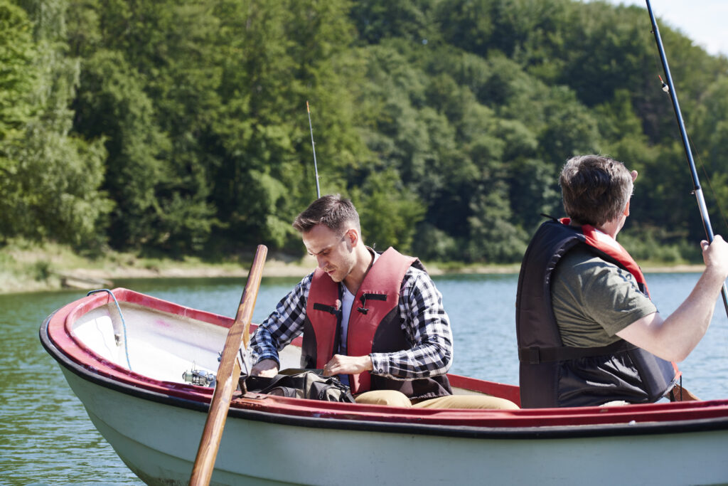 buying a paddle boat showing a pedal-powered watercraft on a calm lake with two seats representing what to consider when buying a paddle boat sizes brands Sun Dolphin parts and maintenance
